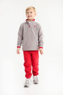 A young boy wears a cozy grey quarter-zip fleece pullover with red trim and matching Gates Sweeney Sweatpants - Richmond Red with Nantucket Navy Stork.