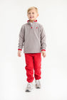 A young boy wears a cozy grey quarter-zip fleece pullover with red trim and matching Gates Sweeney Sweatpants - Richmond Red with Nantucket Navy Stork.