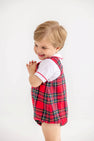 A toddler wearing a white Peter Pan collar shirt under a Barr Clay Bubble - Society Prep Plaid with Worth Avenue White & Richmond Red bubble romper.
