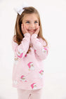 A girl wearing a Cassidy Comfy Crewneck - Dear Santa (Palm Beach Pink Stripe) with Palm Beach Pink, a long-sleeved crewneck decorated with Santa Claus illustrations and snowflakes.