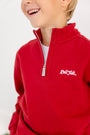 A child wears The Beaufort Bonnet Company’s Alabama Hayword Half-Zip in Alabama Crimson with Alabama Grey and Worth Avenue White, featuring “Roll Tide” embroidered in white on the chest. With only the lower part of their face and upper body visible, this cozy half-zip is perfect for game day layering.