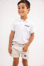 A smiling young boy wears a white Michigan polo shirt and “Michigan Critter Sheffield Shorts - Saratoga Stone” by The Beaufort Bonnet Company, decorated with multiple M logos, standing against a plain white background.