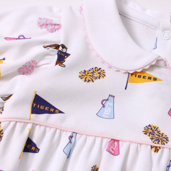 LSU Britt Bubble - Tenacious Tigers with Palm Beach Pink by The Beaufort Bonnet Company: A white pima cotton bubble featuring a playful Tenacious Tigers print with LSU and Tigers flags, pom-poms, and megaphones in purple, gold, and pink. This design includes puffed sleeves, a Peter Pan collar, light pink trim at the waist, and is crafted for comfort and Southern charm.