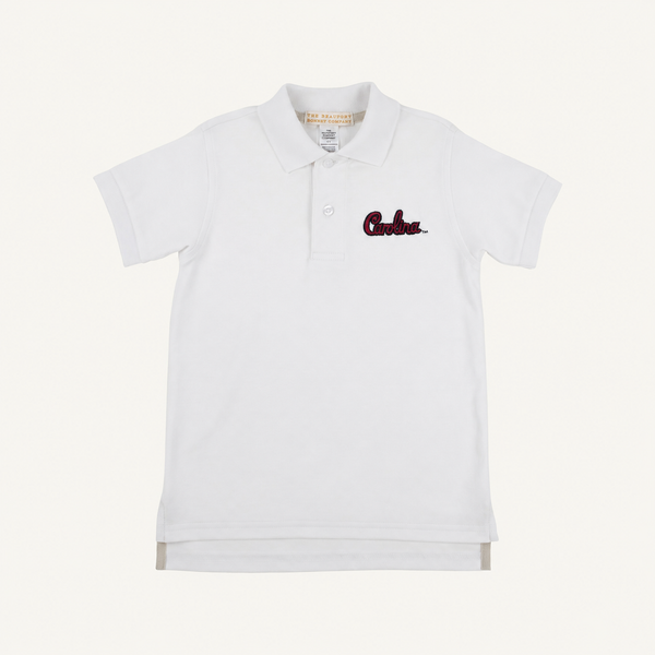 The South Carolina Prim & Proper Polo in Worth Avenue White by The Beaufort Bonnet Company is a white short-sleeve polo shirt featuring a collar, buttons, and an embroidered red South Carolina logo on the left chest. Crafted from soft Pima Cotton Knit, this polo offers a clean, classic look with its plain white background.