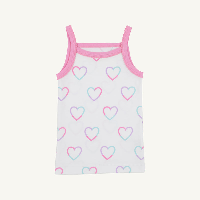 The Caroline Camisole - Have a Little Heart with Winter Park Pink by The Beaufort Bonnet Company is a white children’s tank top made from soft Pima Cotton, accented with pink trim and adorned with a whimsical heart pattern in pastel pink, blue, and purple, shown on a plain background.