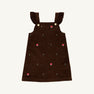 The Beaufort Bonnet Company Critter Julia Jumper in Chelsea Chocolate corduroy features ruffled shoulder straps, gold buttons, and small embroidered red fox faces with green plants scattered across the fabric.