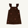 The Beaufort Bonnet Company Critter Julia Jumper in Chelsea Chocolate corduroy features ruffled shoulder straps and delightful fox embroidery with red fox faces and tiny green plants, shown against a white background.