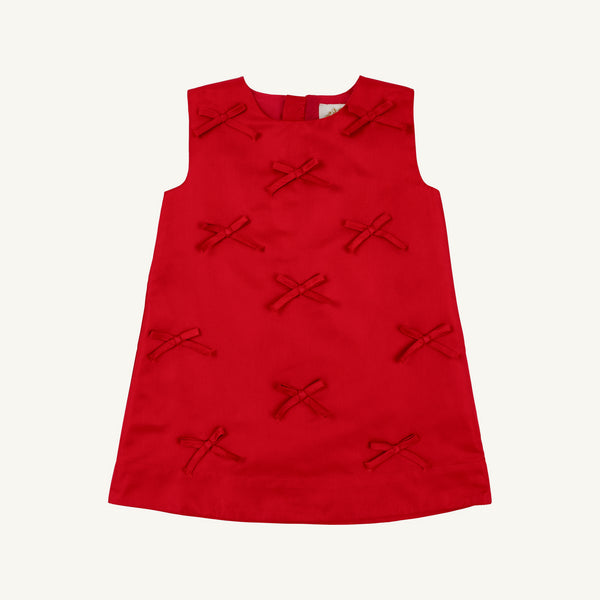 Sleeveless Grandccasion™ Jilly Jumper in Richmond Red Taffeta from The Beaufort Bonnet Company, featuring a simple A-line silhouette adorned with multiple small red fabric bows on the front. Set against a plain white background, this girls’ special occasion dress stands out beautifully.
