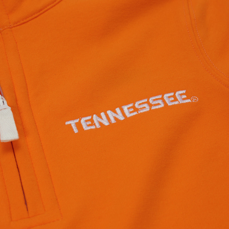 Close-up of The Beaufort Bonnet Company’s Tennessee Hayword Half-Zip in Tennessee Orange with Worth Avenue White, featuring a white zipper and the word TENNESSEE embroidered in white, slightly curved on the right side—a perfect gameday layering piece for true Vols style.