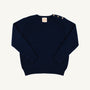 Isabelle’s Sweater in Nantucket Navy is a long-sleeved cotton sweater for girls featuring three brass-colored buttons on the left shoulder.