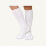 A person wearing cozy white Jefferies Cable Knit Knee Socks.