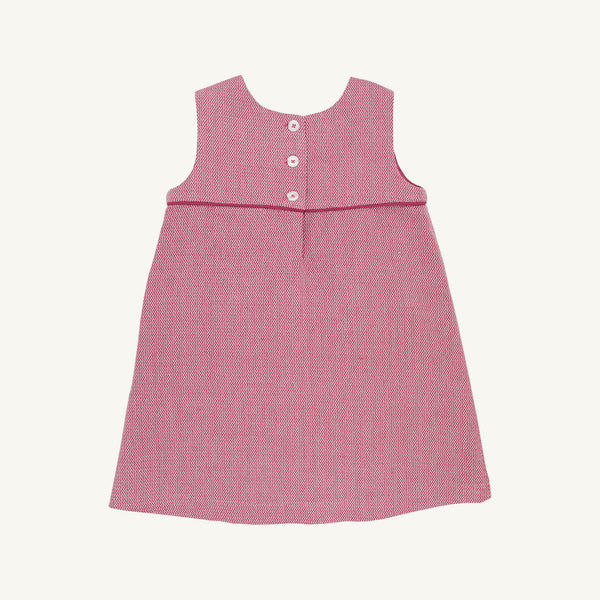 The Jill Jumper - Begley Berry Tweed by The Beaufort Bonnet Company is a sleeveless pink girls jumper dress featuring a textured pattern, an empire waistline, and three white buttons on the back. It is displayed laid flat on a plain white background.