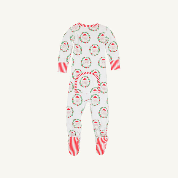 Introducing the Knox’s Night Night - North Pole Portrait with Richmond Red Stripe by The Beaufort Bonnet Company: a white baby onesie featuring festive Santa faces and wreaths, finished with vibrant red cuffs and feet. Cheerful red and white stripes accent the feet, while a small back flap in matching print adds an extra adorable detail.
