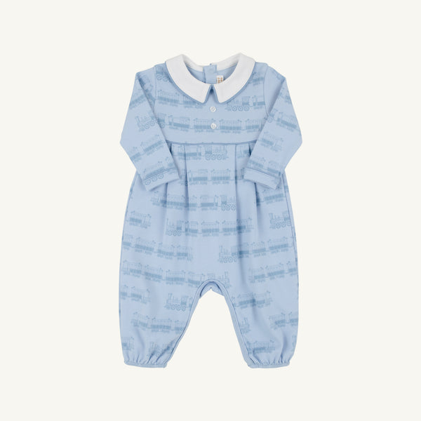The Beaufort Bonnet Company’s Long Sleeve Bradford Romper - Blue Choo Choos with Worth Avenue White features a light blue design with a crisp white collar, charming chest buttons, and a subtle Blue Choo Choos train pattern. Expertly crafted from super-soft Pima Cotton, this romper combines comfort and timeless style.
