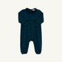 The Beaufort Bonnet Company’s Long Sleeve Bradford Romper in Woodlake Point Plaid with Nantucket Navy features blue and green plaid, a navy collar, and elasticized ankles, displayed flat on a white background.