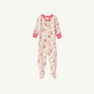 Noelle’s Night Night - Gourd-geous (Palmetto Pearl) with Palm Beach Pink from The Beaufort Bonnet Company is a cozy baby sleeper featuring long sleeves, footed legs, pink cuffs, and a charming floral print adorned with pink and red flowers and fruits. A small pink bow decorates the neckline. The sleepwear is displayed on a white background.