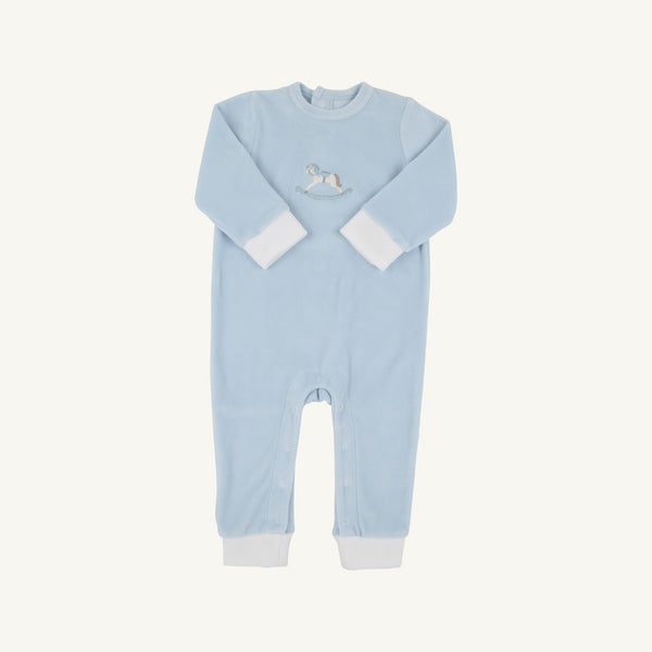 The Beaufort Bonnet Company’s Paxton Playsuit in Buckhead Blue features long sleeves, white cuffs and ankle bands, and an embroidered rocking horse on the chest. Designed for easy changing, it includes snap closures along the legs.