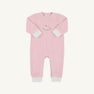 The Beaufort Bonnet Company’s Paxton Playsuit in Palm Beach Pink features crisp white cuffs, a charming rocking horse embroidery on the chest, and convenient leg snaps for easy changing.