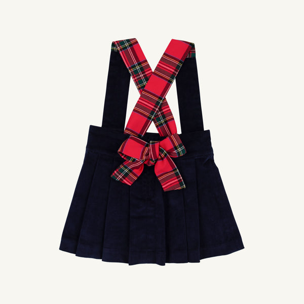 Pearl Prep Skirt in navy blue Nantucket corduroy, featuring crisscrossed Society Prep plaid suspender straps and a large matching bow at the waist.