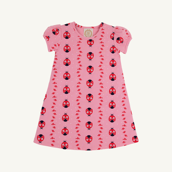 Penny’s Play Dress - Ladybug Line Up by The Beaufort Bonnet Company: A pink short-sleeve dress adorned with a charming pattern of red and black ladybugs and small red leaves, crafted from soft Pima Cotton and displayed on a white background.