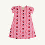 Penny’s Play Dress - Ladybug Line Up by The Beaufort Bonnet Company: A pink short-sleeve dress adorned with a charming pattern of red and black ladybugs and small red leaves, crafted from soft Pima Cotton and displayed on a white background.