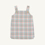 The Beaufort Bonnet Company’s Pleated Ginny Jumper in Manalapan Plaid features an A-line, sleeveless silhouette with shoulder straps and gold buttons, showcasing a pastel pink, blue, and green plaid—perfect for fall styling and displayed on a simple background.