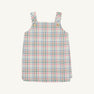 The Beaufort Bonnet Company’s Pleated Ginny Jumper in Manalapan Plaid features an A-line, sleeveless silhouette with shoulder straps and gold buttons, showcasing a pastel pink, blue, and green plaid—perfect for fall styling and displayed on a simple background.
