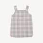 The Beaufort Bonnet Company’s Pleated Ginny Jumper in Manalapan Plaid, a sleeveless dress with thick shoulder straps featuring a pastel pink, green, blue, and white plaid pattern, is displayed laid flat on a plain background.