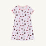 Introducing the USC Polly Play Dress – South Carolina Spirit with Palm Beach Pink by The Beaufort Bonnet Company. This short-sleeved dress is crafted from soft Pima Cotton and showcases a pink-collared design adorned with South Carolina Gamecocks logos, pennants, and mascots in maroon, pink, purple, and blue against a crisp white background for true South Carolina spirit.
