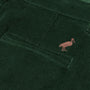 Close-up of a dark green corduroy pocket from The Beaufort Bonnet Company’s Prep School Pants in Grier Green, featuring a small embroidered Gray Bay Brown stork logo above the pocket.