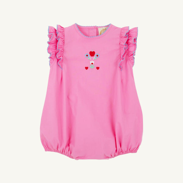 The Beaufort Bonnet Company’s Ruehling Ruffle Bubble in Hamptons Hot Pink features Beale Street Blue trim and floral heart embroidery on the chest, displayed on a white background.