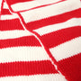 Close-up of The Beaufort Bonnet Company’s Seller’s Scarf in Richmond Red & Palmetto Pearl Stripe, showcasing its knit texture and bold red-and-white horizontal stripes. The cotton knit scarf is neatly folded, displaying a prominent seam along the center.