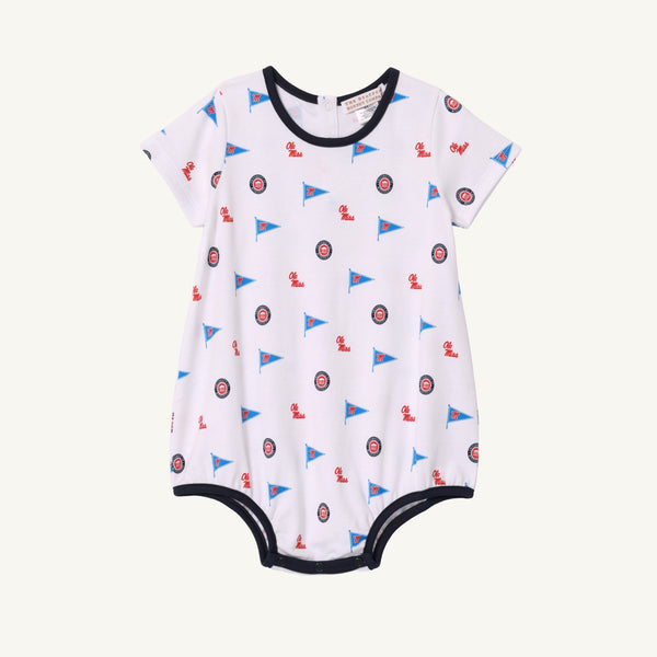 Ole Miss Short Sleeve Patton Play Bubble - Gawsh Almighty with Nantucket Navy by The Beaufort Bonnet Company, crafted from soft Pima Cotton and adorned with small blue flags and circular red, white, and blue emblems. Finished with dark blue trim along the neck, sleeves, and leg openings—perfect for little Ole Miss fans.