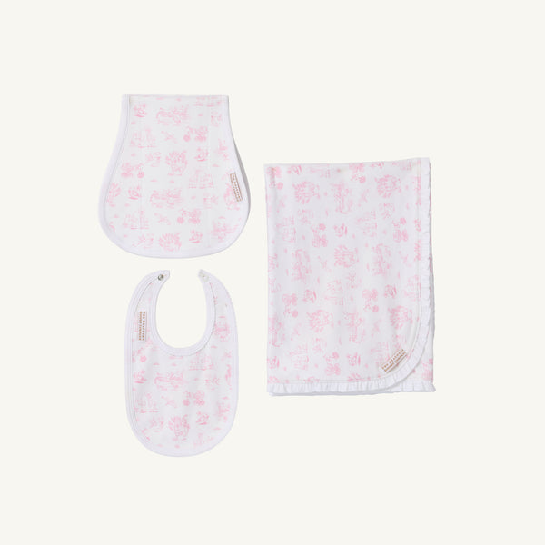 Introducing Sir Proper’s Sweet Arrival (Hamptons Hot Pink) Accessories Bundle by The Beaufort Bonnet Company—a delightful set featuring a Baby Buggy Blanket with a ruffled edge, an Oopsie Daisy Burp Cloth, and a Burp Me Bib. Each item is crafted in crisp white adorned with light pink Hamptons Hot Pink patterns. Beautifully arranged on a plain white background, this charming trio makes the perfect baby shower gift.