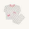 The Beaufort Bonnet Company’s Snooze Button Set – North Pole Portrait with Richmond Red Stripe features a white long-sleeve pajama top adorned with festive Christmas wreath prints and finished with red-striped cuffs and collar. The coordinating pants, displayed flat on a light background, have a comfortable drawstring waist and matching wreath pattern.