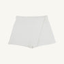 Stella Skort - Quilted Palmetto Pearl by The Beaufort Bonnet Company: A white quilted skort featuring a wrap-style front and a subtle diamond pattern, perfect as girls’ skirt shorts, shown against a plain white background.
