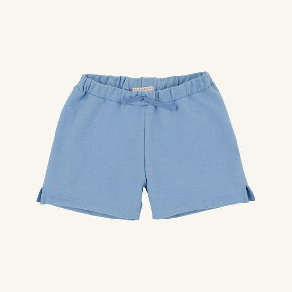 The Beaufort Bonnet Company’s Sullivan Shorts in Barrington Blue Heathered feature an elastic waistband, a small fabric bow at the center front, and subtle side slits at the leg openings. Shown here in a light blue heathered fabric against a plain white background.
