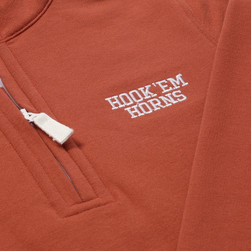 A close-up of The Beaufort Bonnet Company’s Texas Hayword Half-Zip in Texas Burnt Orange with Worth Avenue White, featuring a white zipper and HOOK EM HORNS embroidered in white on the chest—perfect for Longhorn gameday.