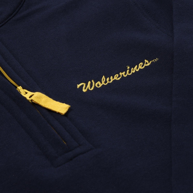 Show your Michigan spirit on game day with the Michigan Hayword Half-Zip from The Beaufort Bonnet Company, featuring Michigan Blue fabric, a contrasting Michigan Maize zipper, and “Wolverines” embroidered in maize script above the zippered pocket—ideal for stylish layering.