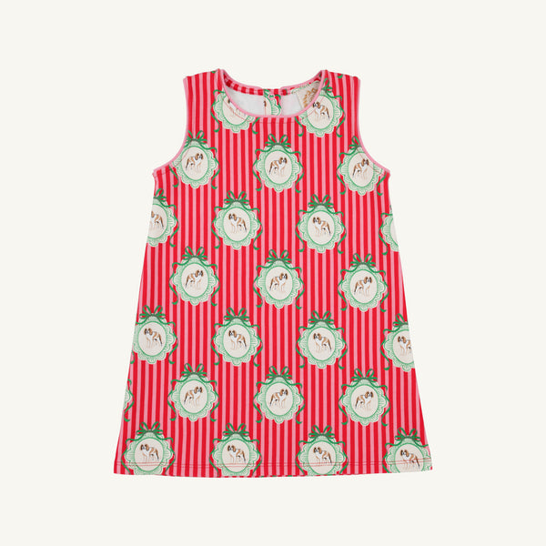 The Annie Apron Dress - Distinguished Doggies with Hamptons Hot Pink is a sleeveless A-line dress in red and white vertical stripes, featuring a repeating print of puppies inside scalloped, green-bowed frames.