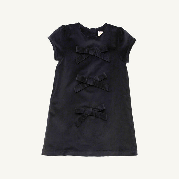 A short-sleeved, dark navy Betts Bow Dress - Newport Night Velveteen featuring three horizontal velvet bows down the center front.
