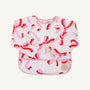 Long-sleeved Biscuit Bib - Bonnie Scot Bows with Hamptons Hot Pink, featuring a pink and red bow pattern with pink trim.