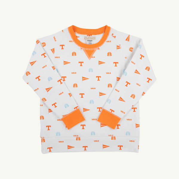 The Beaufort Bonnet Company’s Tennessee Cassidy Comfy Crewneck - Victory in Orange with Tennessee Orange is a white long-sleeve kids’ shirt accented with orange cuffs, collar, and hem. It showcases an all-over University of Tennessee themed print featuring orange T logos, pennants, “VOLS” text, and blue Smokey dog icons—making it a playful and spirited crewneck for young Vols fans.