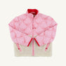 Introducing the Cate Coat - Bluffton Bows with Palmetto Pearl by The Beaufort Bonnet Company: a pink quilted girl’s coat adorned with embroidered bows outlined in red piping, finished with a red zipper and lining. The bottom half features cozy cream-colored sherpa fleece. Stylishly laid flat on a white background, this charming sherpa winter coat is perfect for keeping little ones warm on chilly days.