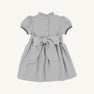 The Beaufort Bonnet Company Cindy Lou Sash Dress in Grantley Gray Houndstooth features short puff sleeves, a ruffled collar, buttons down the back, and a large sash tied at the waist.