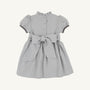 The Beaufort Bonnet Company Cindy Lou Sash Dress in Grantley Gray Houndstooth features short puff sleeves, a ruffled collar, buttons down the back, and a large sash tied at the waist.