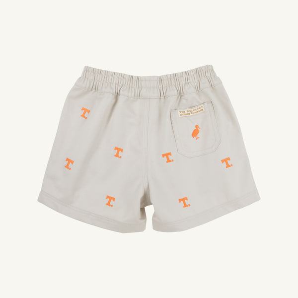 The Beaufort Bonnet Company’s Tennessee Critter Sheffield Shorts in Saratoga Stone feature an elastic waistband, orange T logo embroidery, and a back pocket detailed with a small orange bird and stitched label. Crafted from 100% cotton, these light-colored shorts are shown laying flat on a neutral background.