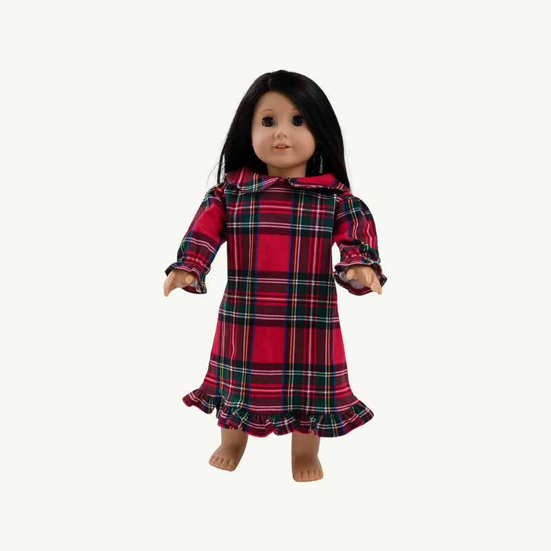 A doll with long dark hair wearing a Dolly’s Goldie Locks Nightgown - Society Prep Plaid featuring a Peter Pan collar, long sleeves with ruffled cuffs, and a ruffled hem.