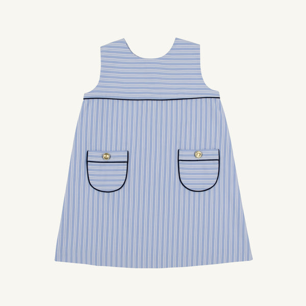 The Jill Jumper - Park City Periwinkle Stripe with Nantucket Navy is a light blue and white sleeveless piece featuring two patch pockets with dark navy trim and a gold button on each pocket.