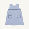 The Jill Jumper - Park City Periwinkle Stripe with Nantucket Navy is a light blue and white sleeveless piece featuring two patch pockets with dark navy trim and a gold button on each pocket.